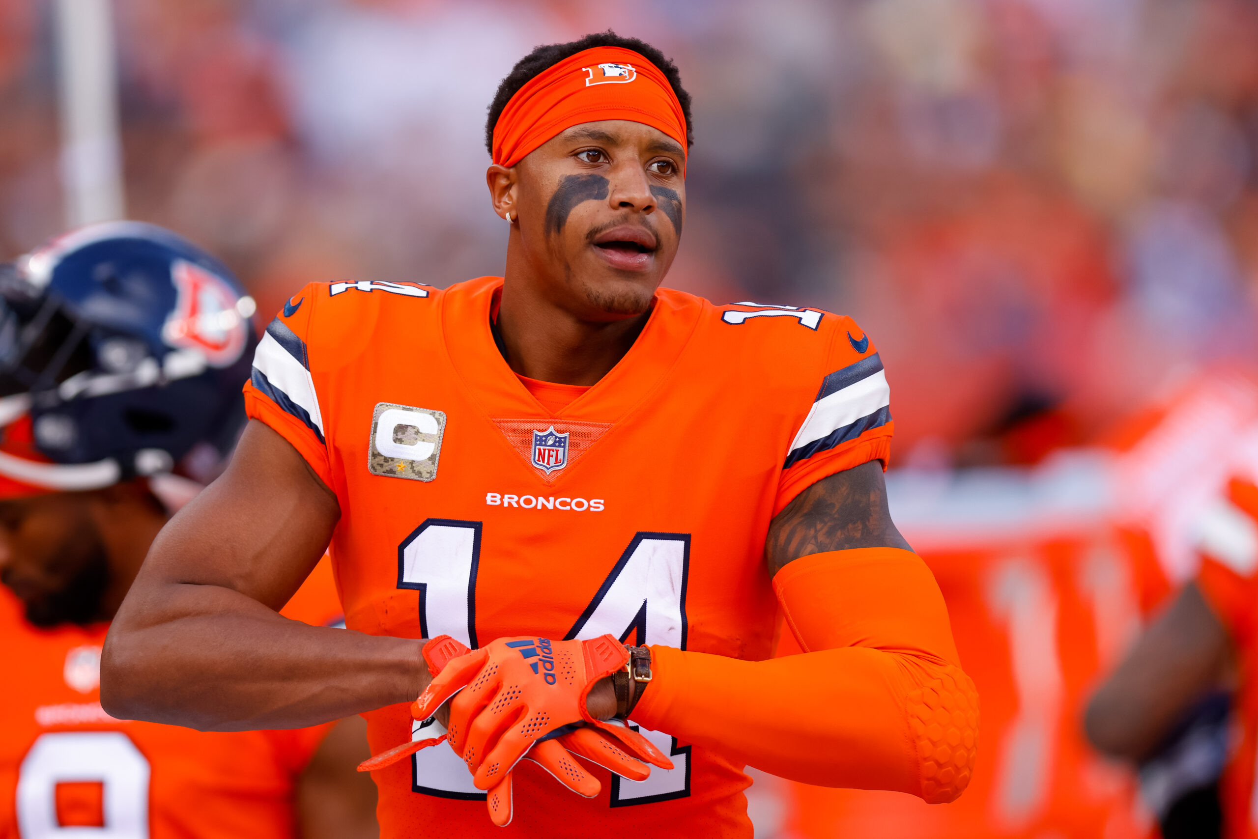 Wide receiver Courtland Sutton #14 of the Denver Broncos adjusts his gloves on the sidelines during the first half against the Philadelphia Eagles at Empower Field at Mile High on November 14, 2021 in Denver, Colorado.