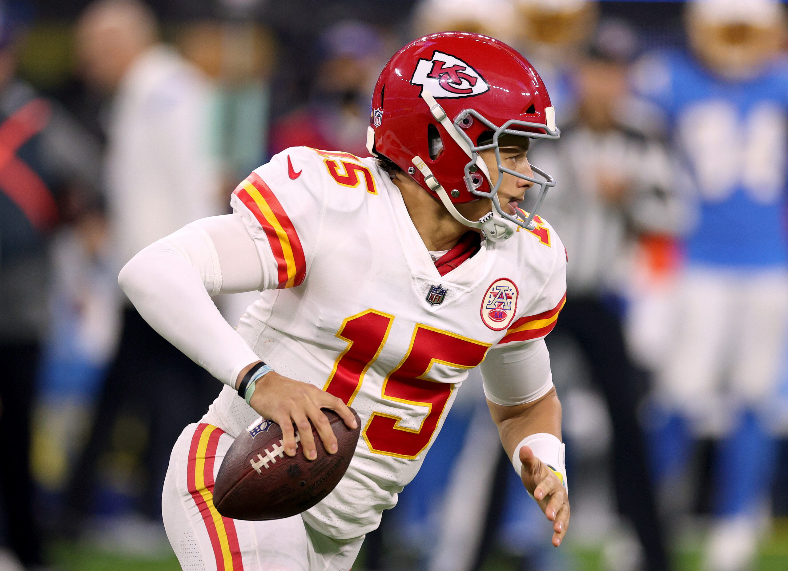 Patrick Mahomes #15 of the Kansas City Chiefs scrambles out of the pocket during a 34-28 win over the Los Angeles Chargers at SoFi Stadium on December 16, 2021 in Inglewood, California.