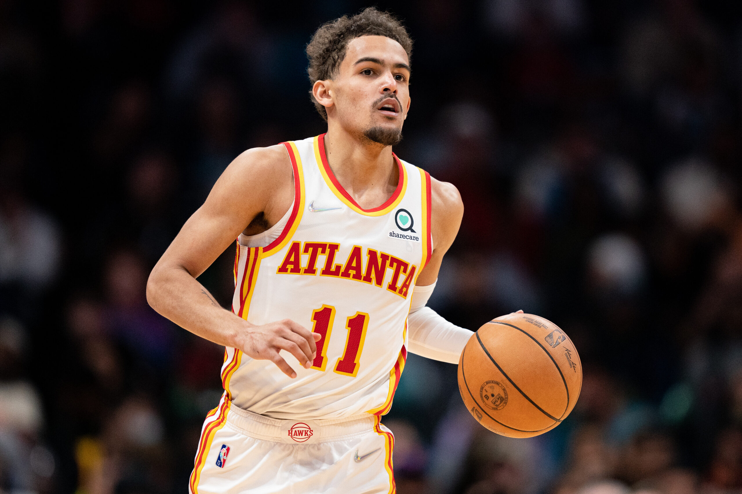 Trae Young #11 of the Atlanta Hawks brings the ball up court against the Charlotte Hornets during their game at Spectrum Center on March 16, 2022 in Charlotte, North Carolina.